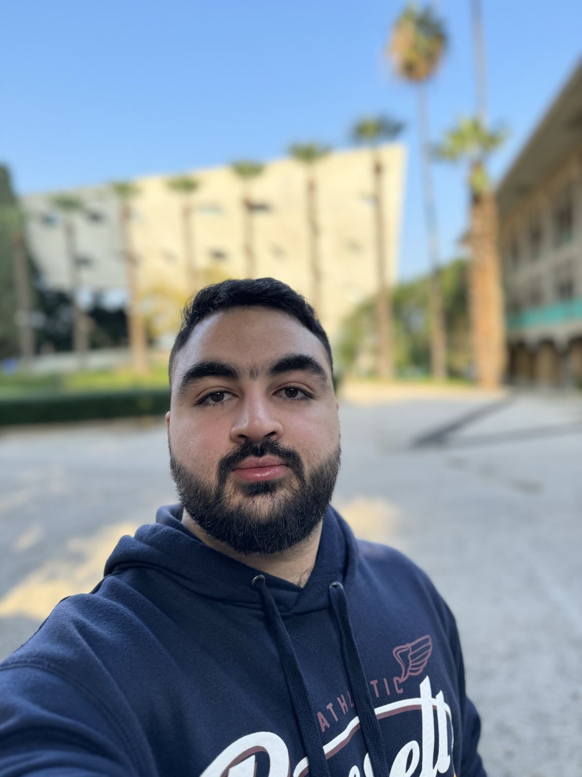 Peter Farah on a palm-lined campus walkway in Beirut