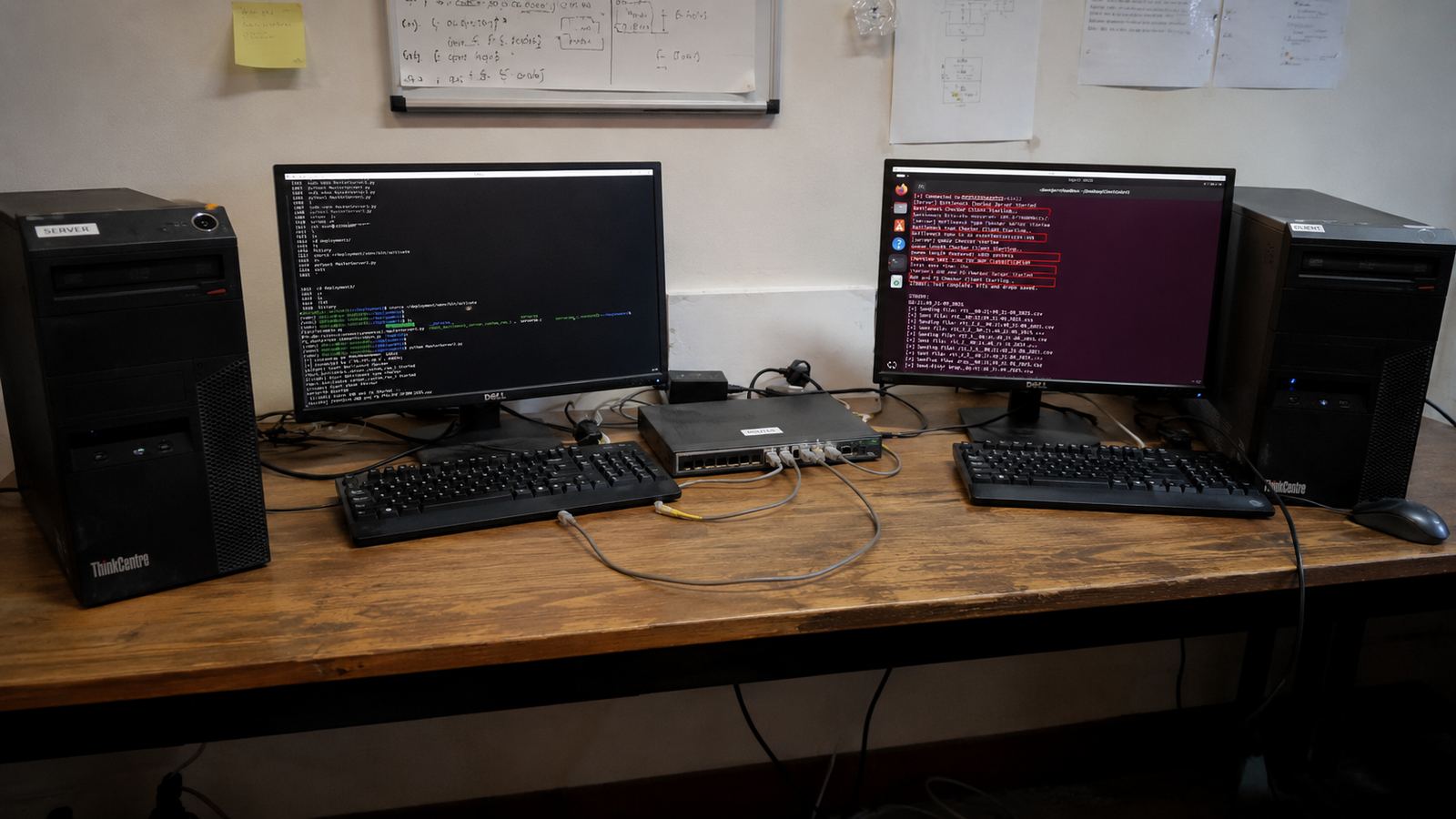 A two-machine network testbed: two desktop towers either side of a switch, with terminals showing bitrate, queue-length and RTT measurements